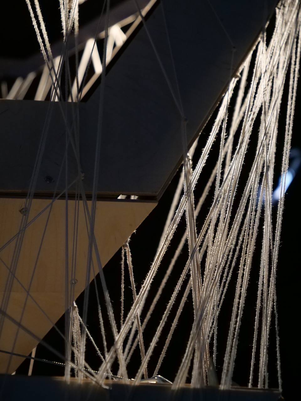 Closeup of threads surrounding the piece, illuminated by light